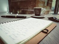 Notebook and pen on a desk — photo by David Bares on Pexels