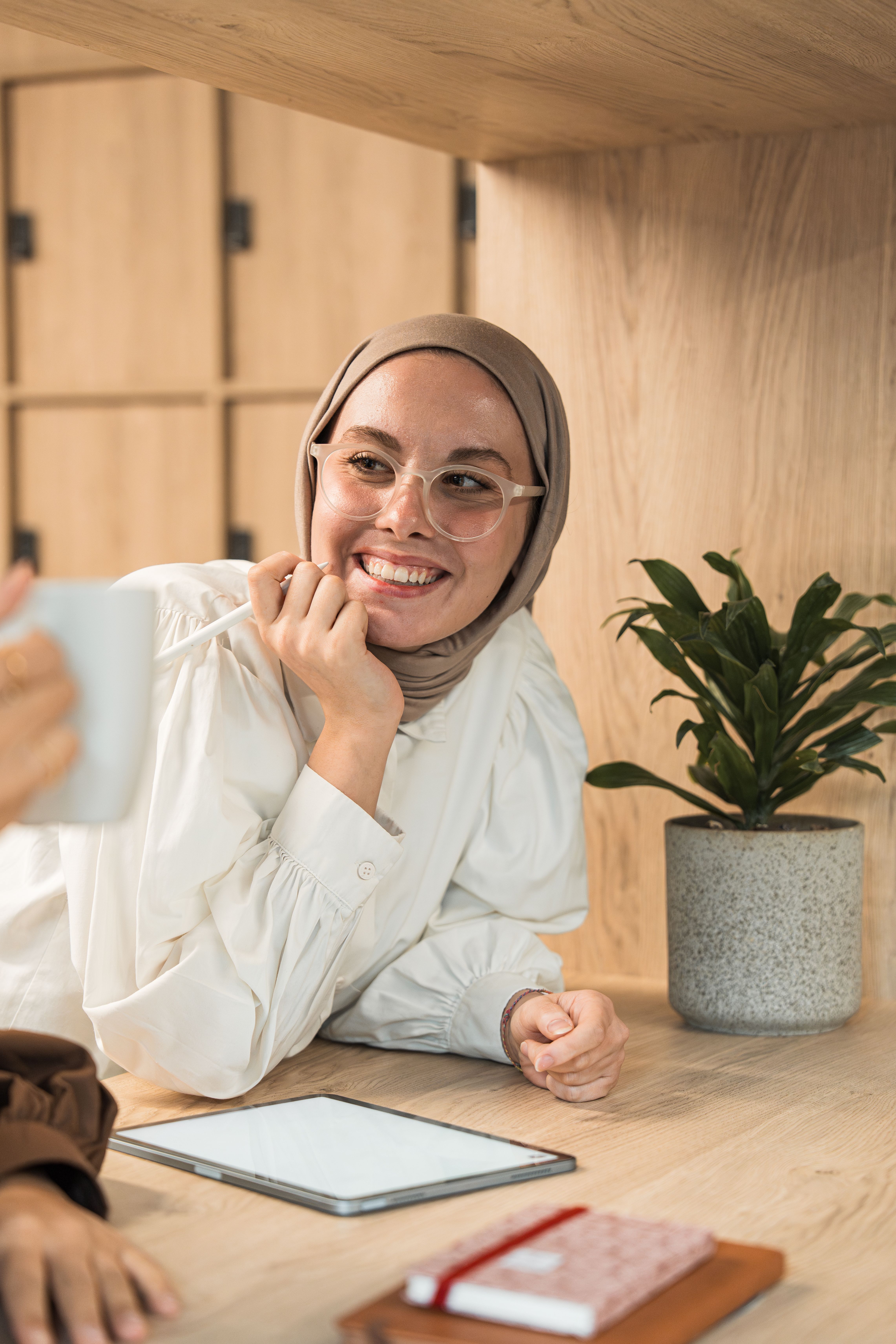 Woman in Hijab Sitting with a Tablet · Free Stock Photo