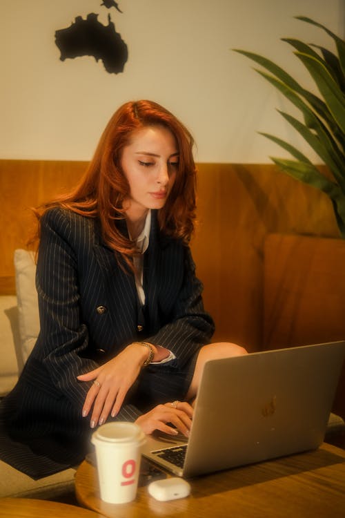 Redhead Woman in Suit Working on Laptop