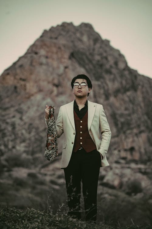 Man in Suit Standing and Holding Shawl