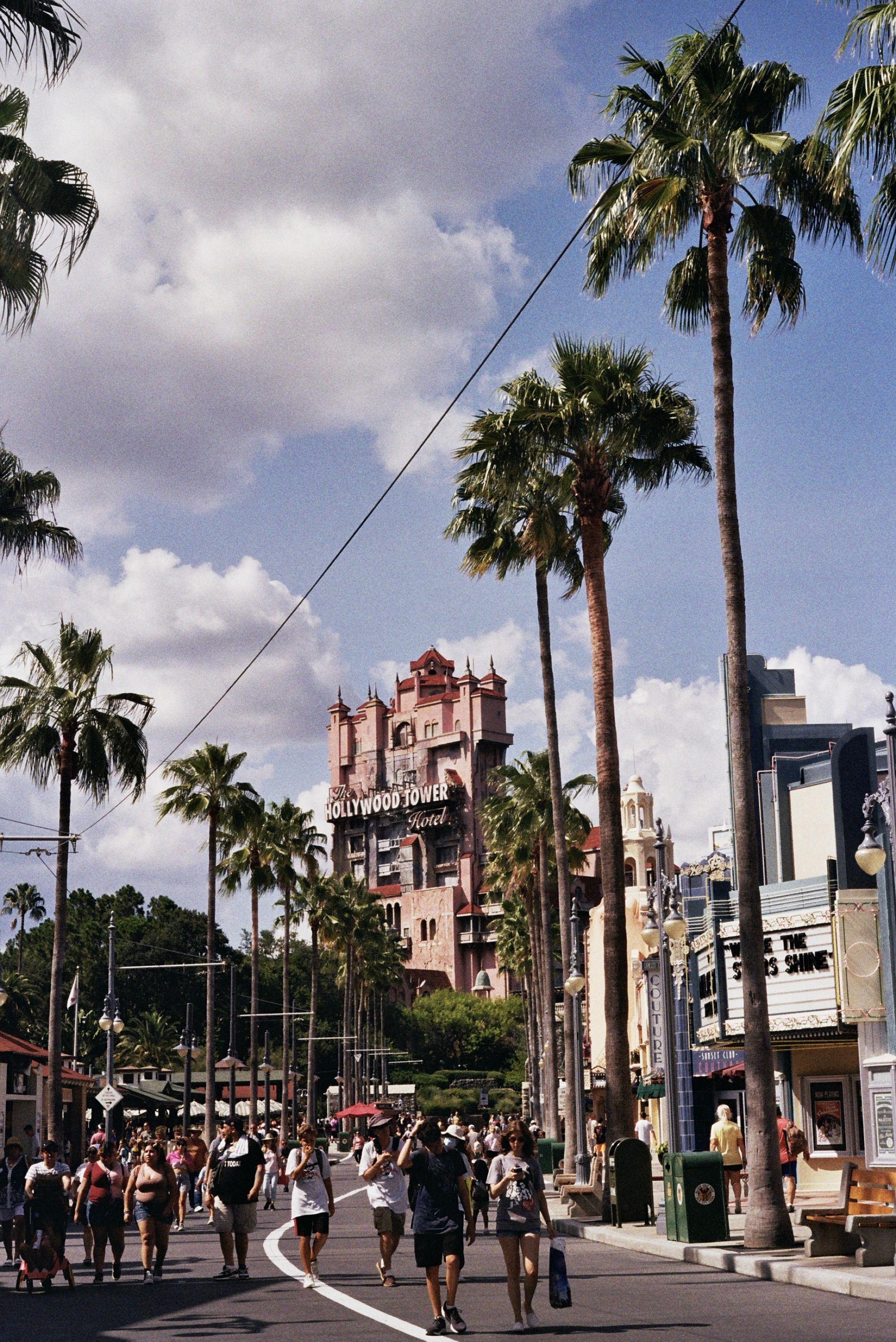Explore Disney's Hollywood Tower at Hollywood Studios, sunny with palm trees.