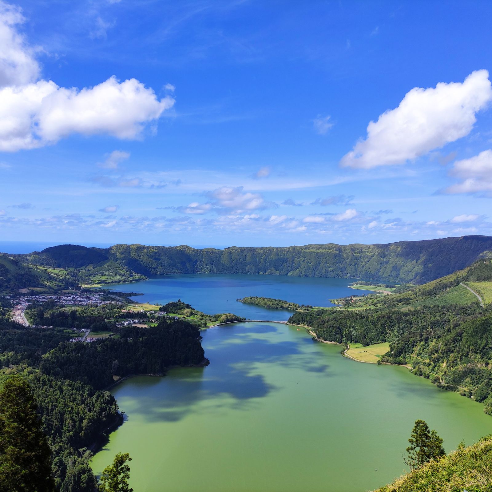 Twin crater lakes ringed by green volcanic hills on a mid-Atlantic island
