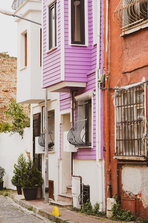A colorful house on a narrow street
