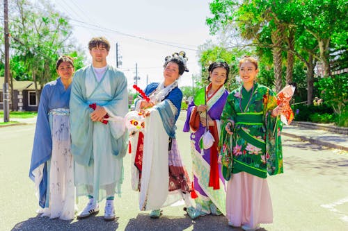 Smiling Women and Man in Traditional Clothing 