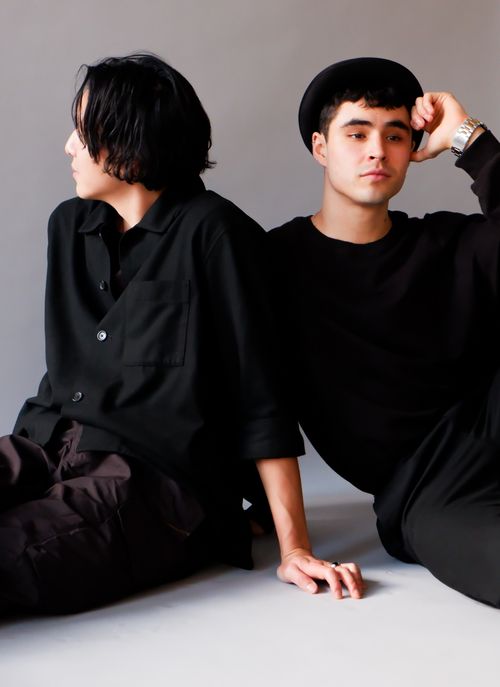 Free Stylish men in black clothing posing together in a studio portrait. Stock Photo