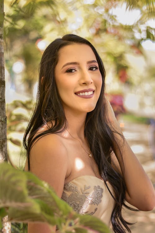 A beautiful young woman in a dress posing for a portrait