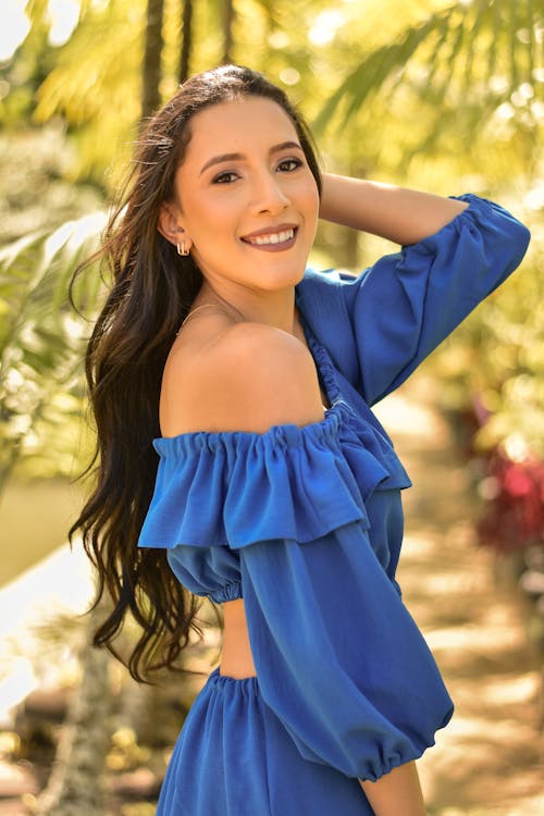 Portrait of Smiling Brunette Woman in Blue Dress