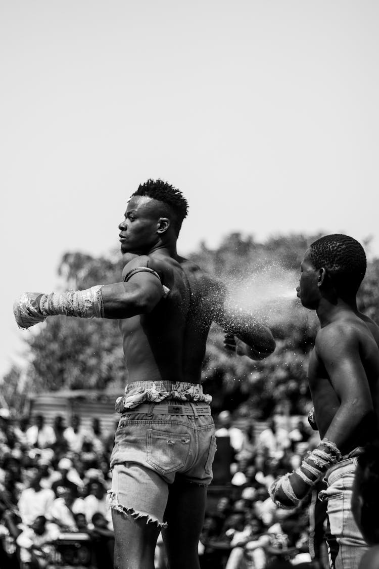 Men Spitting Water At Festival