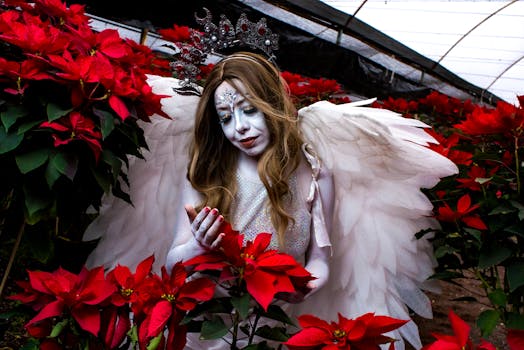 A mystical angelic figure with wings amidst vibrant red poinsettias in Xochimilco, Mexico.