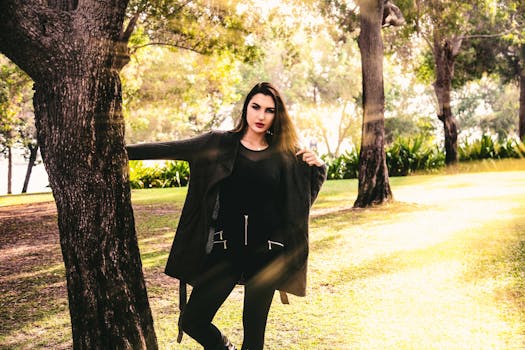 一位时尚女士在阳光明媚的公园里优雅地摆着姿势，展现出自然的优雅与魅力