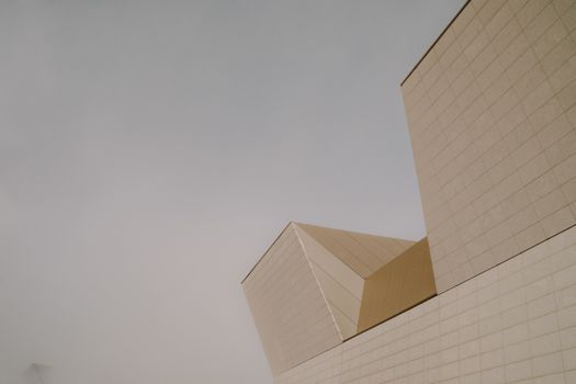 A building with a large white roof and a small building