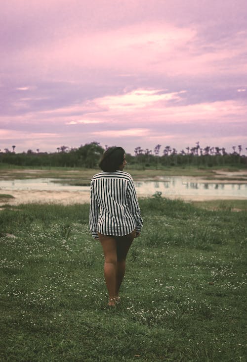 Black woman walking in calm marshland