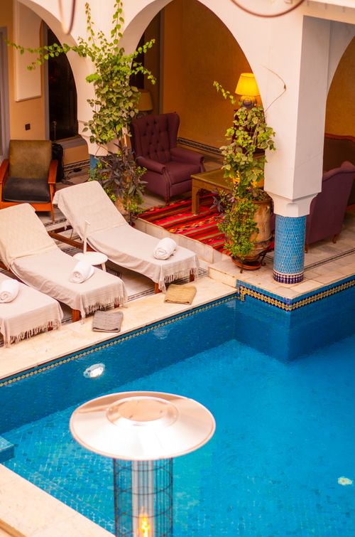 Free Elegant pool area with sunbeds and seating in Marrakesh, Morocco, ideal for relaxation. Stock Photo