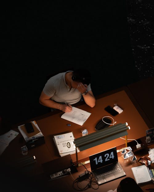 A man sitting at a desk with a laptop