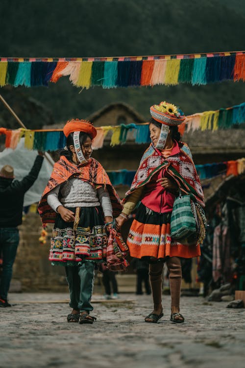 Peruvian Girls Wearing Traditional Clothing, Walking under Festive Decoration