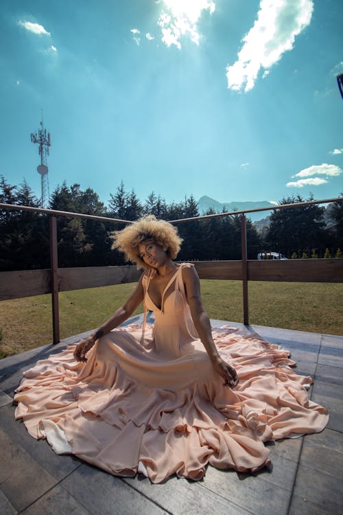 Model in a Pink Evening Dress Sitting on the Terrace