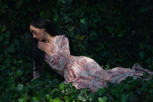 Brunette Woman in Dress and with Leaves around