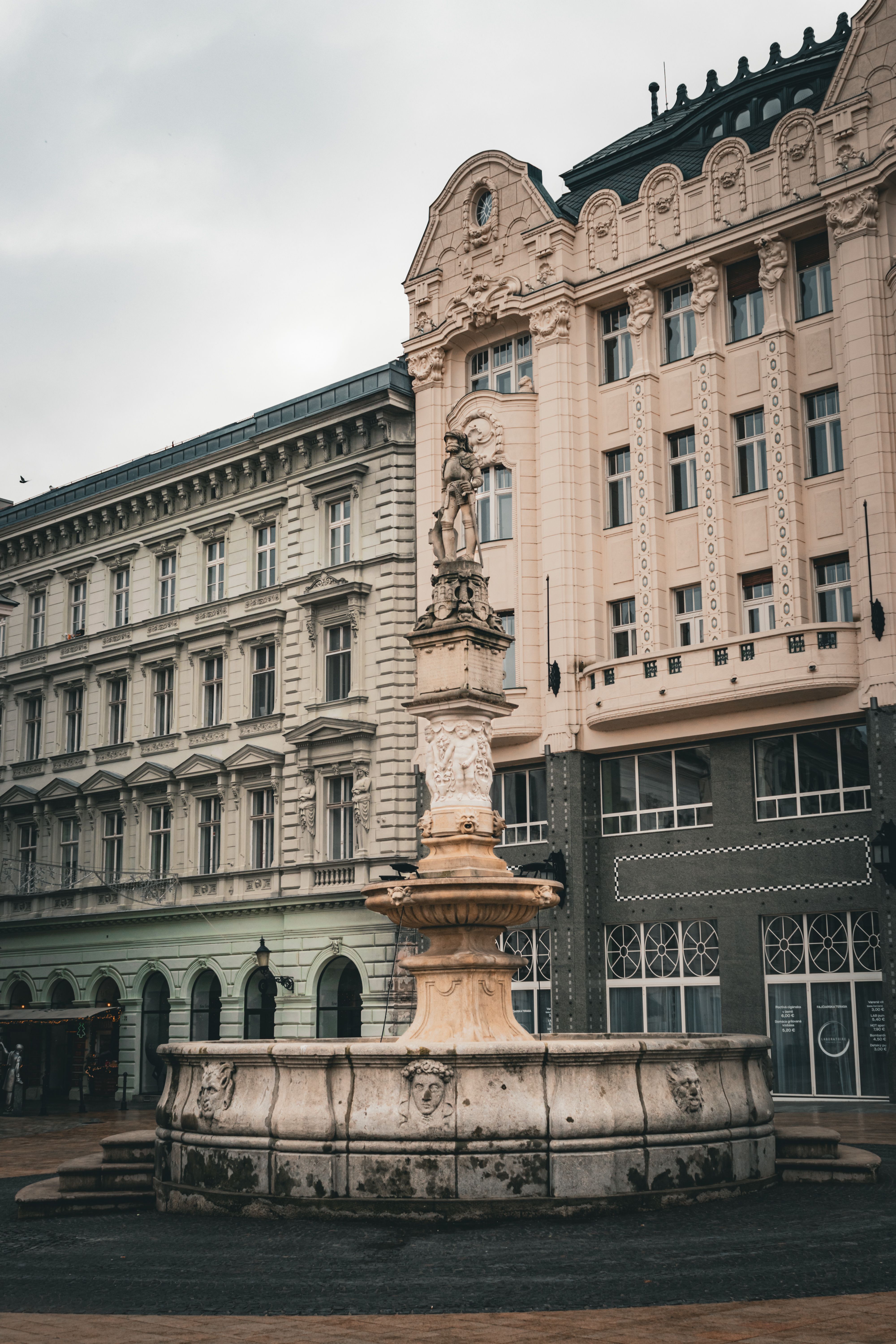 Maximilian's Fountain surrounded by historic architecture in Bratislava, Slovakia.