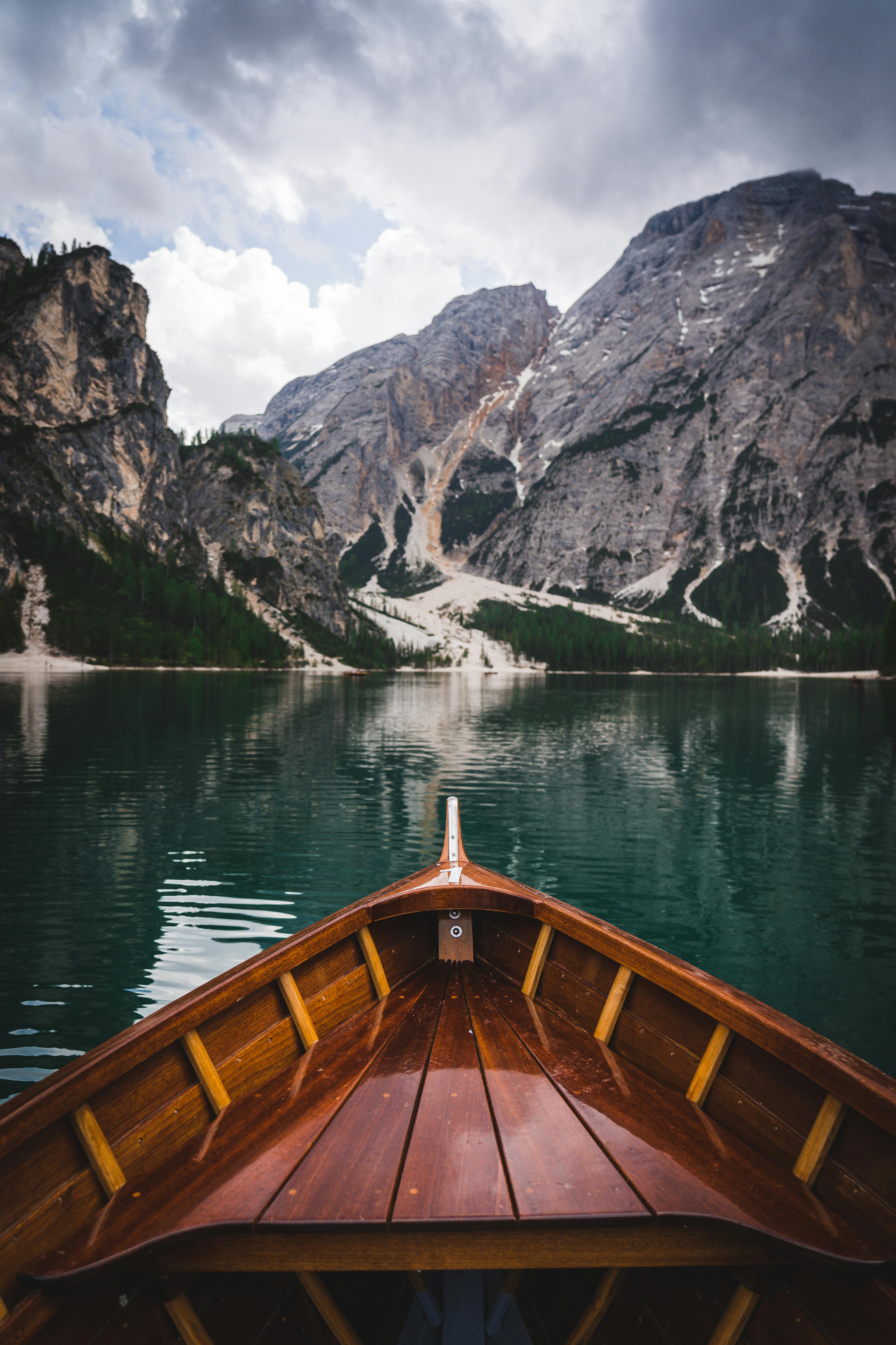 Wooden boat on Lake Braies with stunning mountain view in Trentino-Südtirol, Italy.