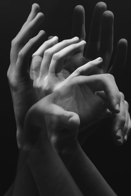 A black and white photo of hands