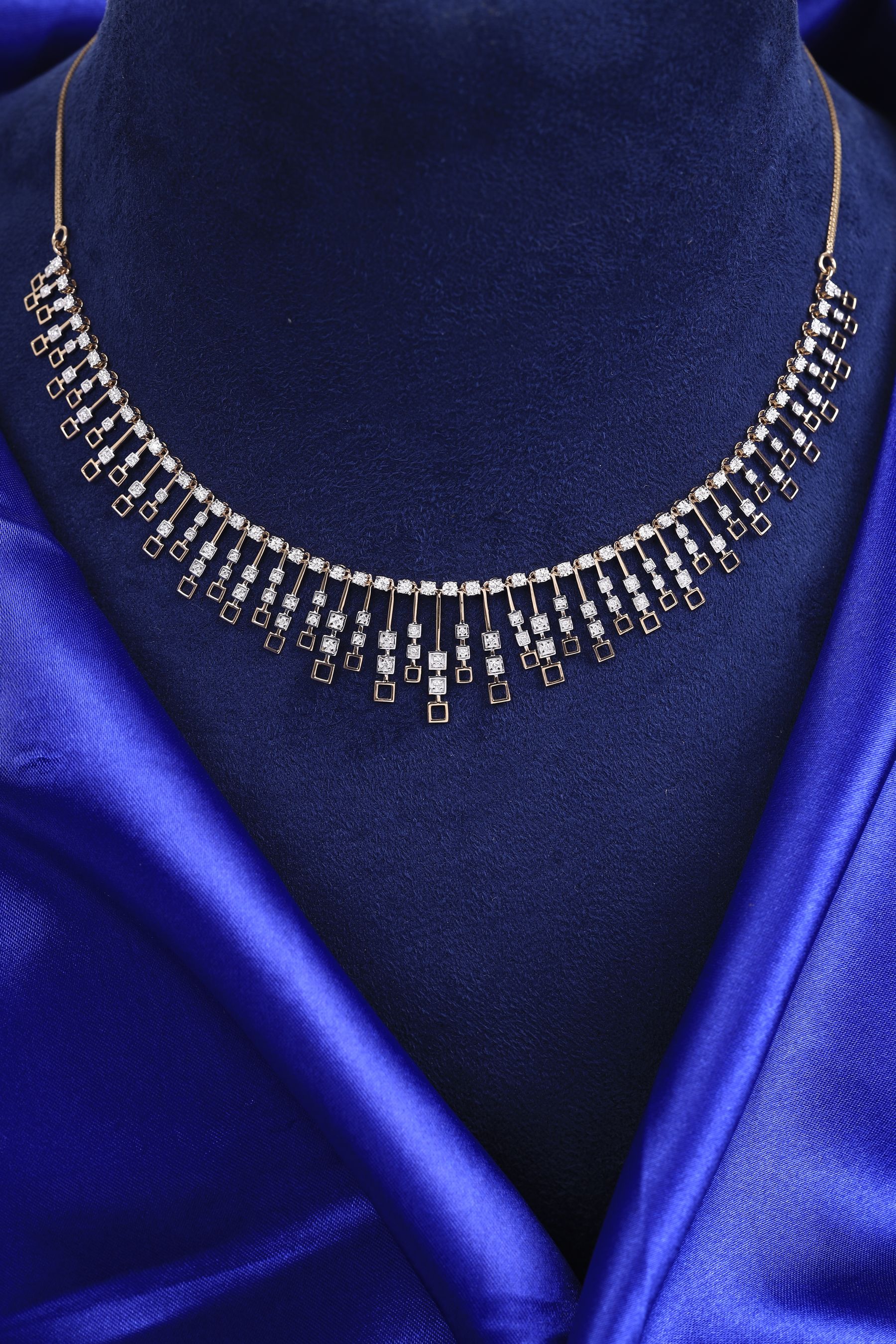 An evening necklace laid on midnight velvet