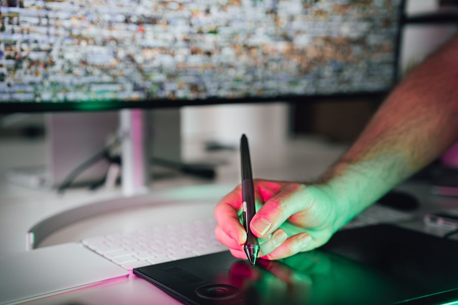 A designer drawing on a digital graphics tablet