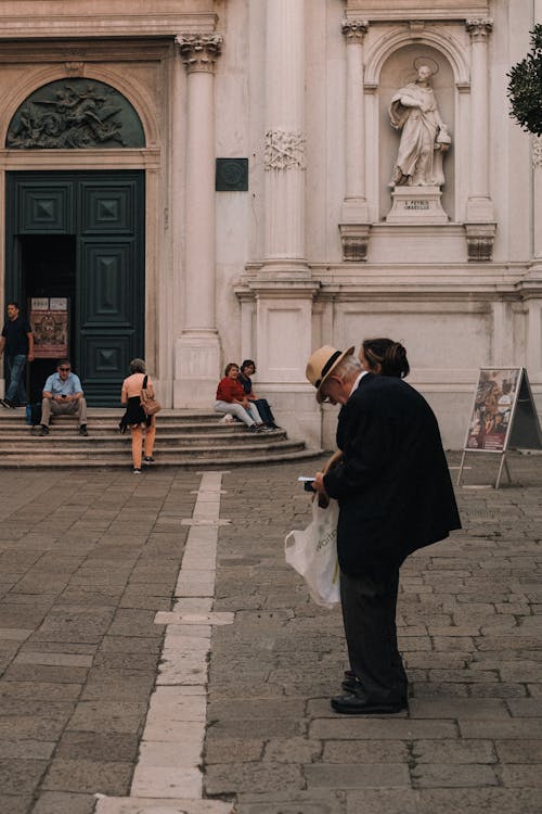 A man and woman are walking down a street