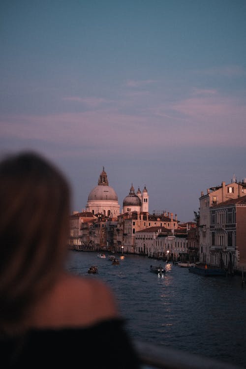 A woman looking at the water in venice