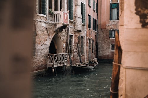 A boat is docked in a canal in venice