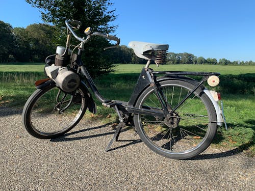 A black bicycle parked on the side of the road