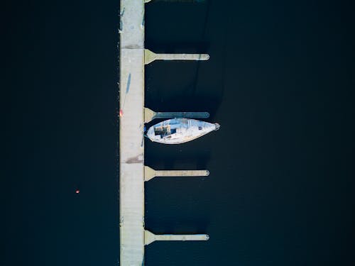 aerial view of sailing boat berthed in empty marina