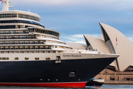 Queen Elizabeth cruise ship docked near Sydney Opera House, Australia at daytime.