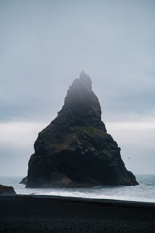 Free Ethereal view of a towering rock formation at Reynisfjara Beach, Iceland. Stock Photo