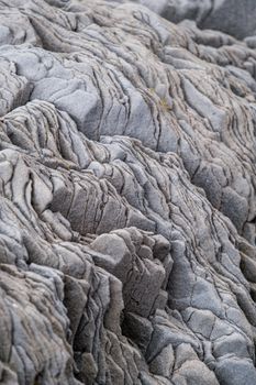 A detailed, high-resolution image showcasing gray eroded rock formations with a textured, rough appearance.
