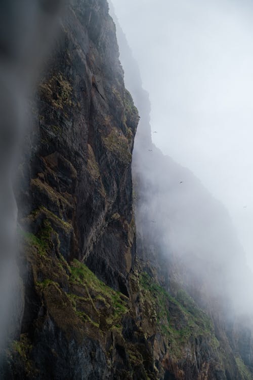 A person is standing on the edge of a cliff