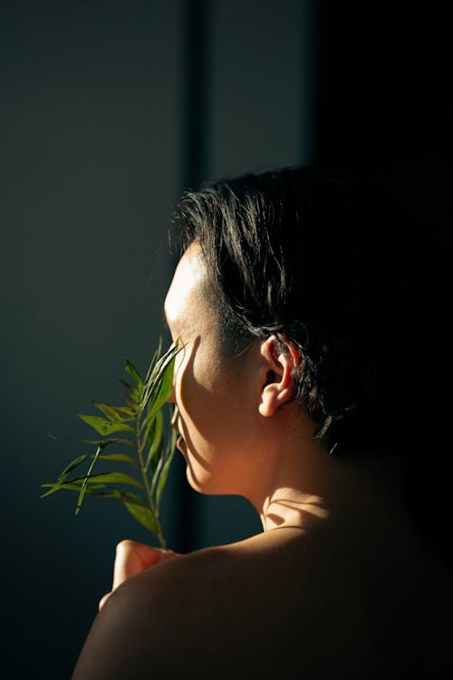 Woman with Green Plant in Sunlight 
