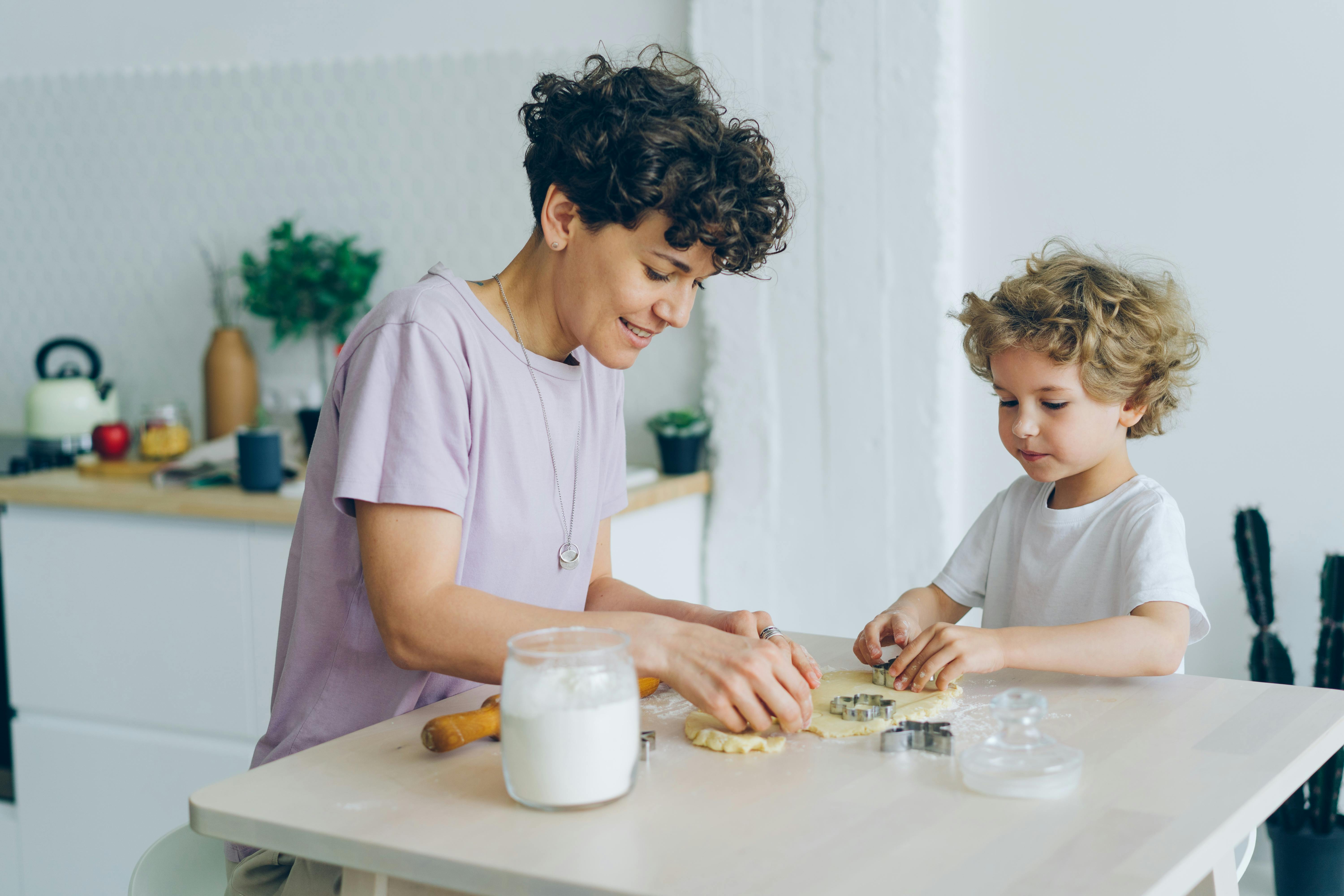 mother and her little son baking in the kitchen