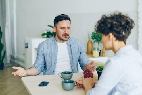Man Arguing with Woman by Table