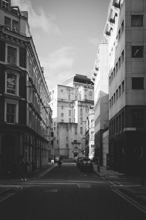 Black and white photo of a street with tall buildings