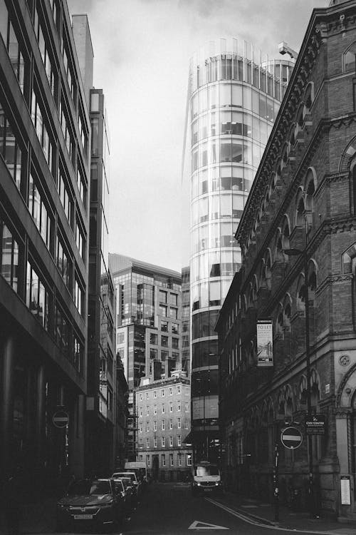 Black and white photo of a street with tall buildings