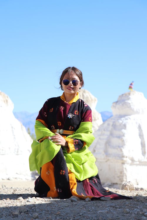 Foto profissional grátis de ajoelhado, jaqueta verde, Mulher asiática