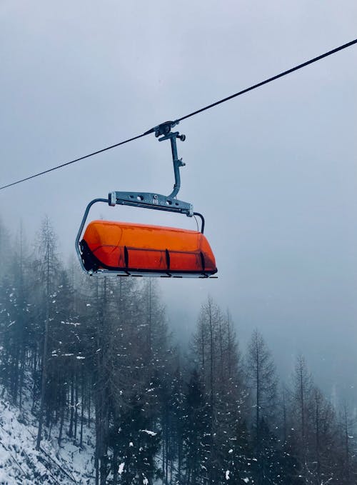 A ski lift with an orange and white cover