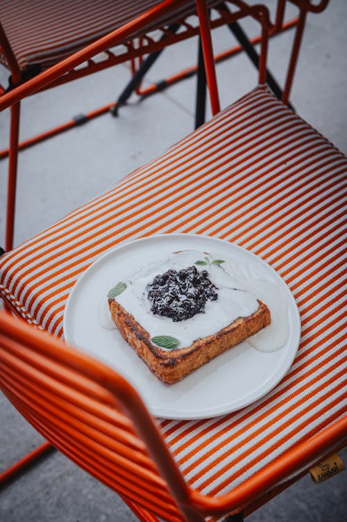 A plate of food on an orange chair