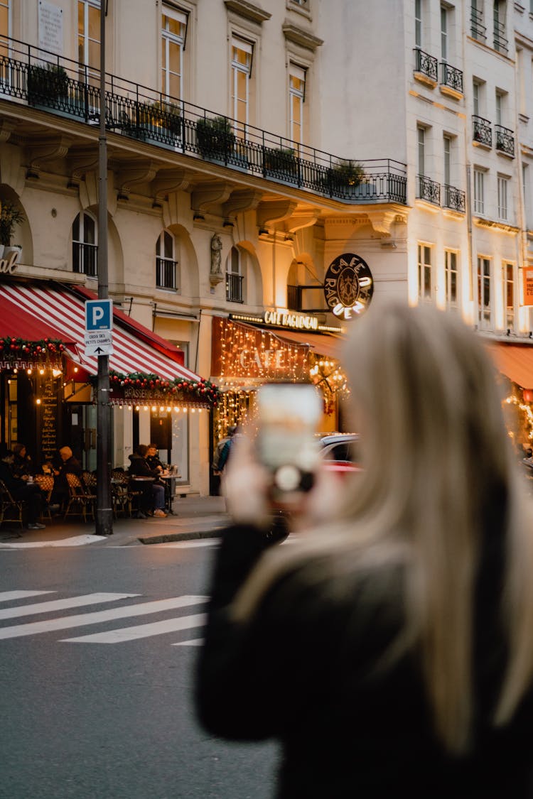 Woman Taking Pictures On Street In Paris