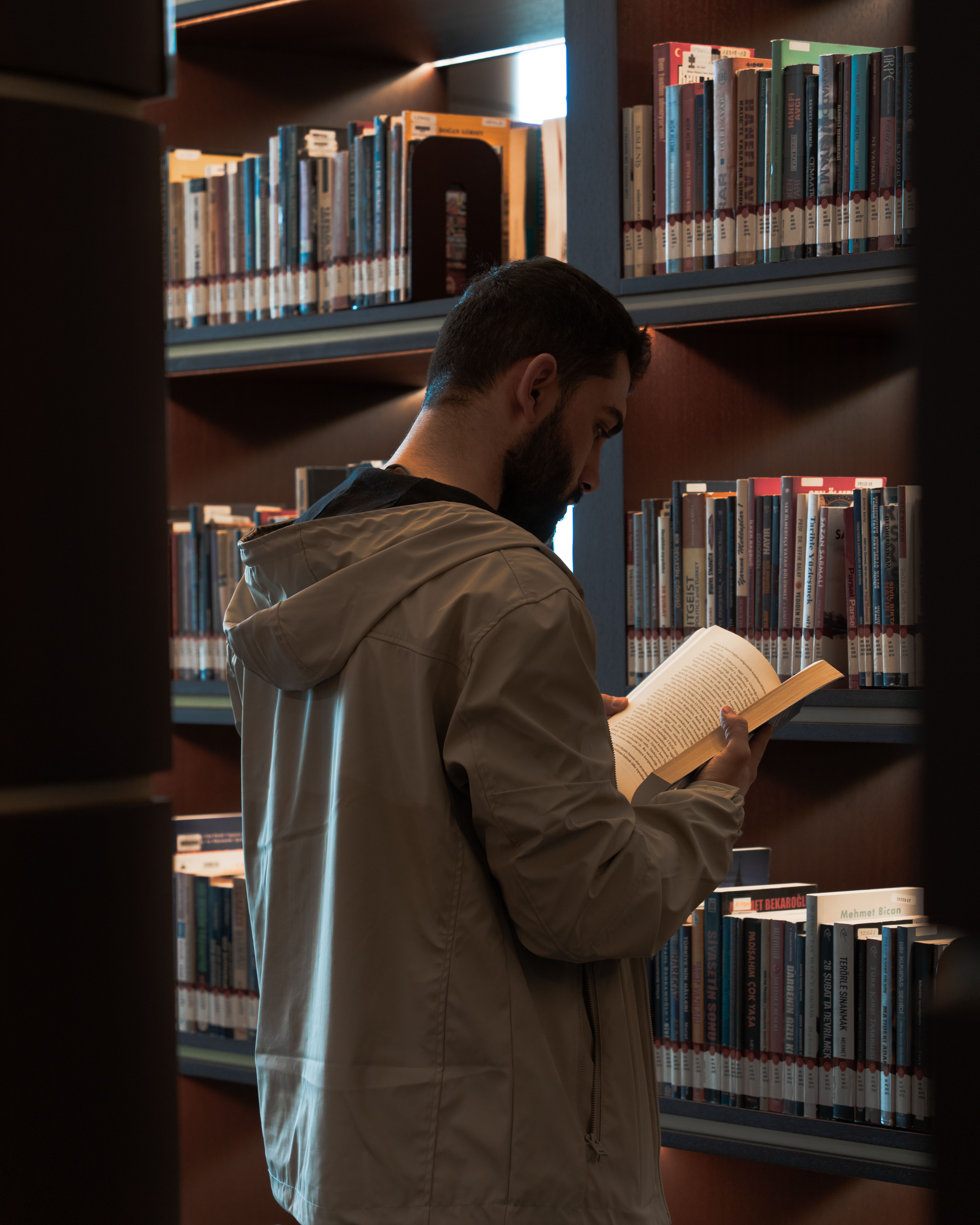 Man Reading a Book in a Library · Free Stock Photo