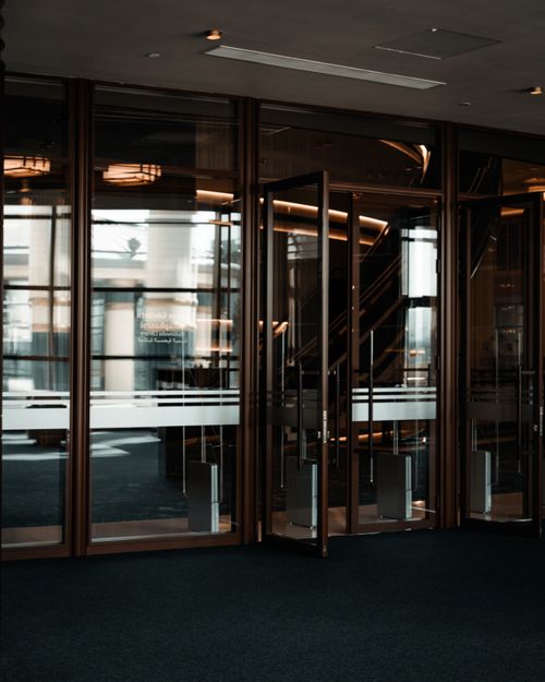 Free Contemporary glass doors and entrance to a corporate building lobby. Stock Photo