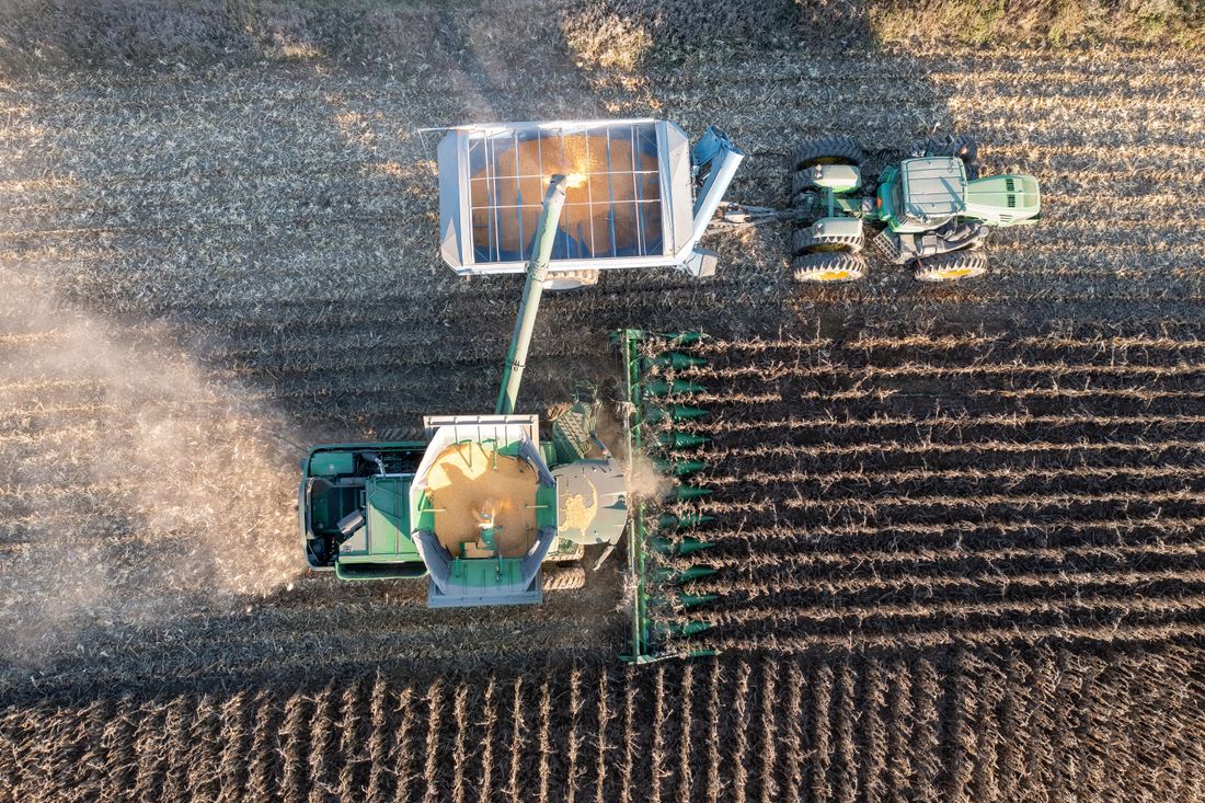 Tractor and harvester working in Minnesota, USA
