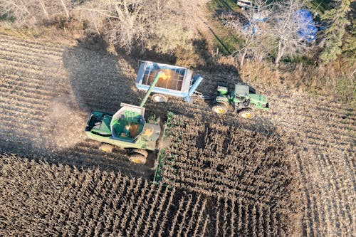 Tractor and Harvester Working on Field