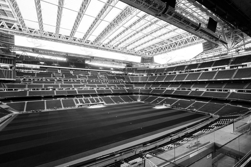 Black and white photograph of a large stadium with retractable roof in Madrid