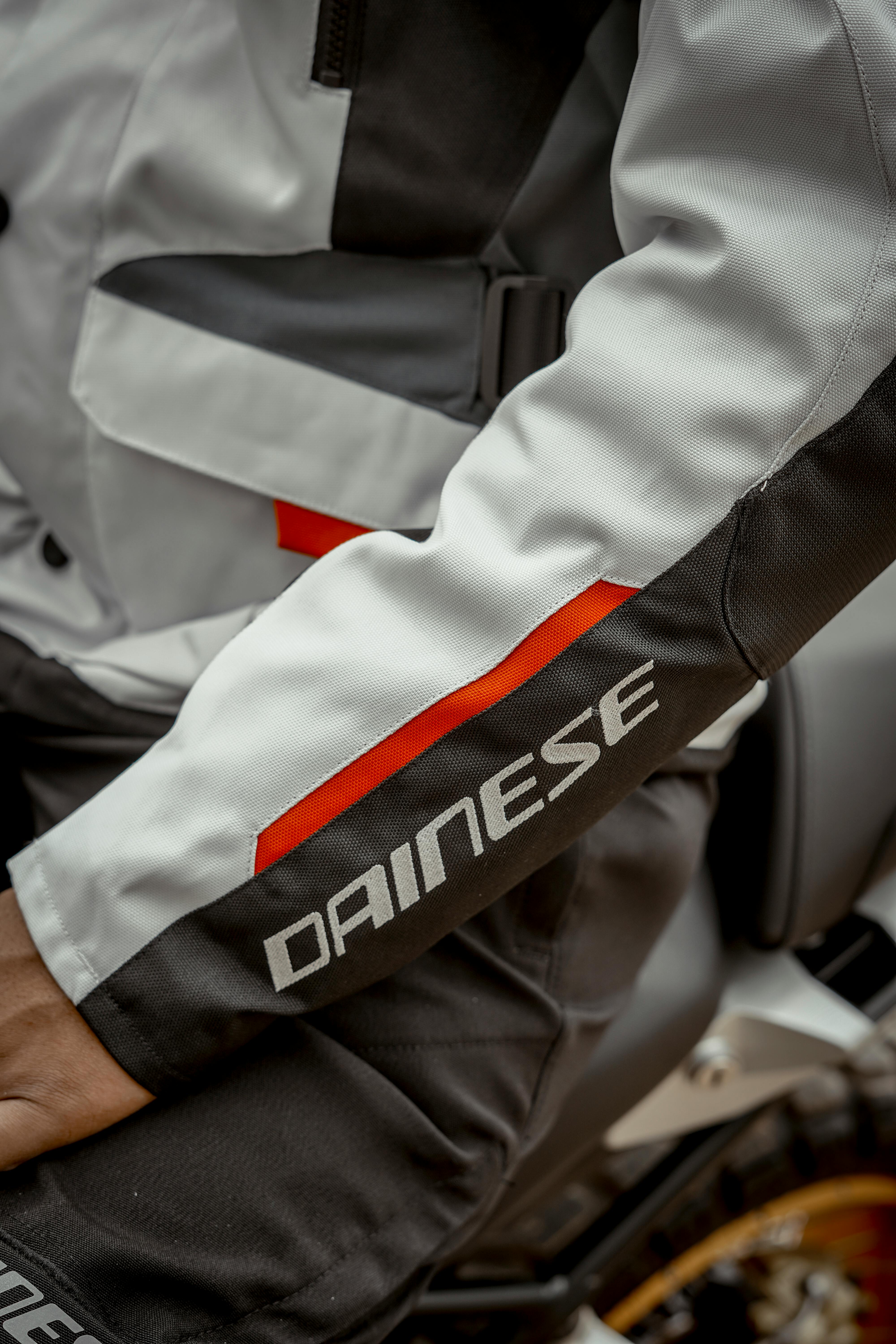 Close-up of a motorcyclist's jacket sleeve featuring Dainese branding in Indio, CA.